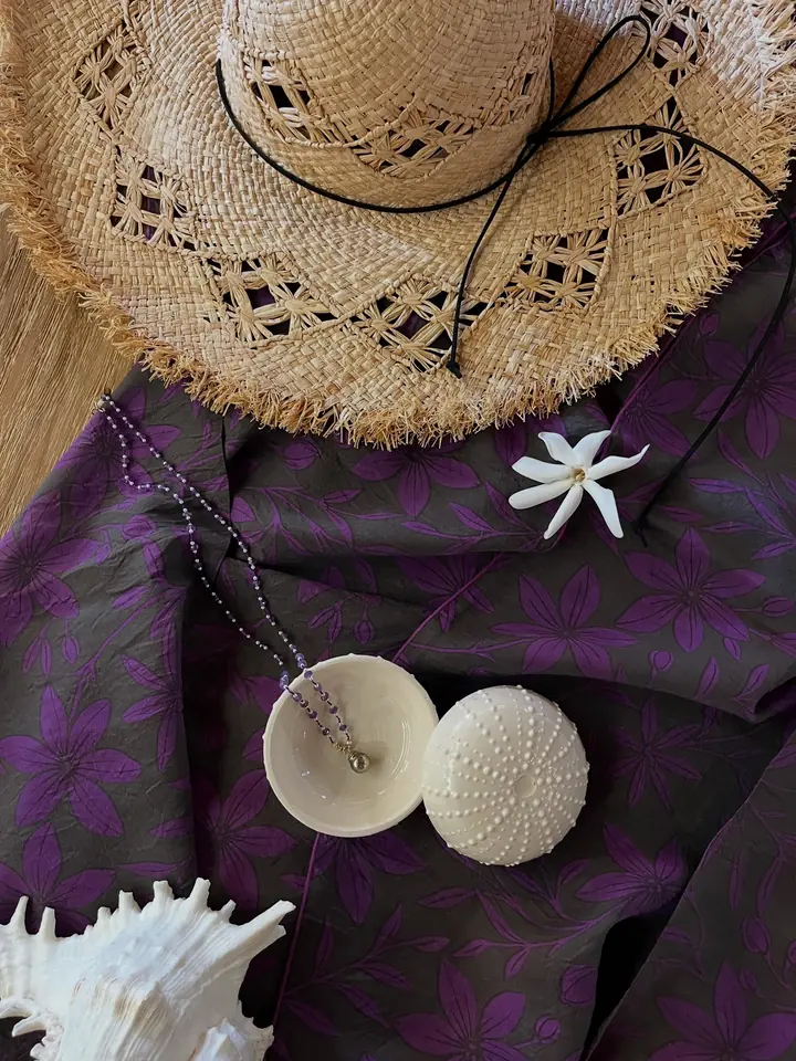 Collier améthyste et perle de Tahiti dans un oursin, chapeau de paille et pāreu violet